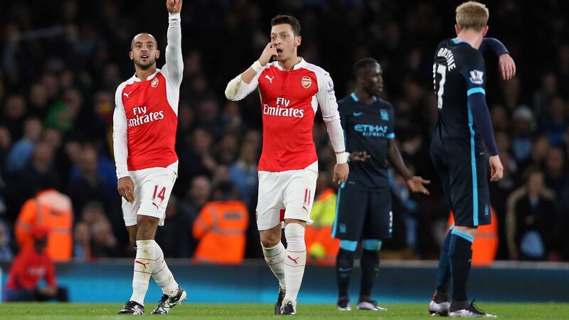 Arsenal's Theo Walcott (left) celebrates with Mesut Ozil after opening the scoring for Arsenal against Manchester City<br />Picture by PA&nbsp;