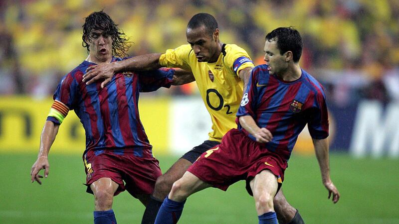 Thierry Henry, centre, tussles with Barcelona's Puyol and Iniesta. On this day, he passed a media ahead of a move to join Barcelona.
