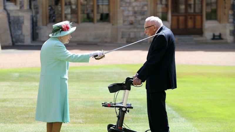 The 100-year-old former Army officer, who raised almost £33 million for the NHS, was joined by his family in Windsor Castle’s quadrangle.