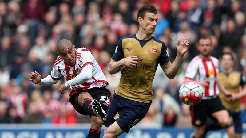 Sunderland's Wahbi Khazri gets away a shot despite the best efforts of Arsenal's Laurent Koscielny during Sunday's Barclays Premier League match at the Stadium of Light<br />Picture by PA