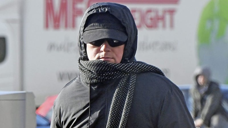 Piotr Dziurdzik hides his face as he leaves Antrim courthouse yesterday. Picture by Justin Kernoghan 