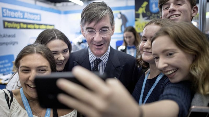 Leader of the House of Commons Jacob Rees-Mogg poses for a photograph with young people during the Tory conference in Manchester, where the mood remains upbeat ahead of the Brexit deadline 
