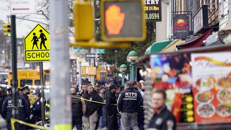 New York City Police Department personnel gather at the entrance to a subway stop in the Brooklyn borough of New York, Tuesday, April 12, 2022 (AP Photo/John Minchillo)&nbsp;