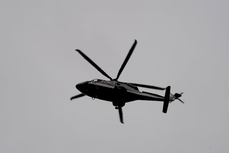 The royal helicopter carrying the King and Queen arrives at Buckingham Palace
