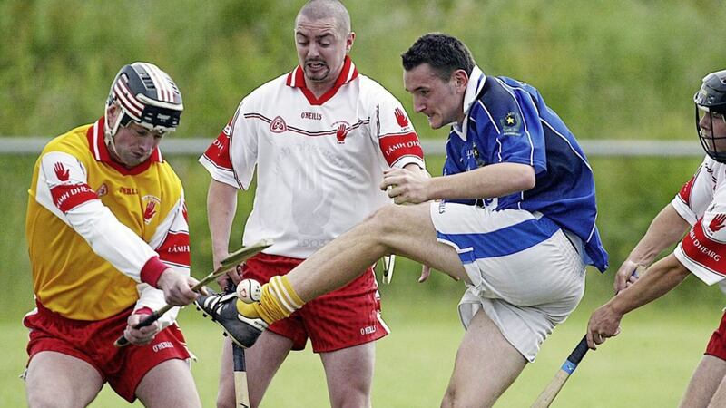 Gary Agnew in action for L&aacute;mh Dhearg against St Gall&#39;s forward Anton McCaffrey. Gary sadly passed away on Friday. 