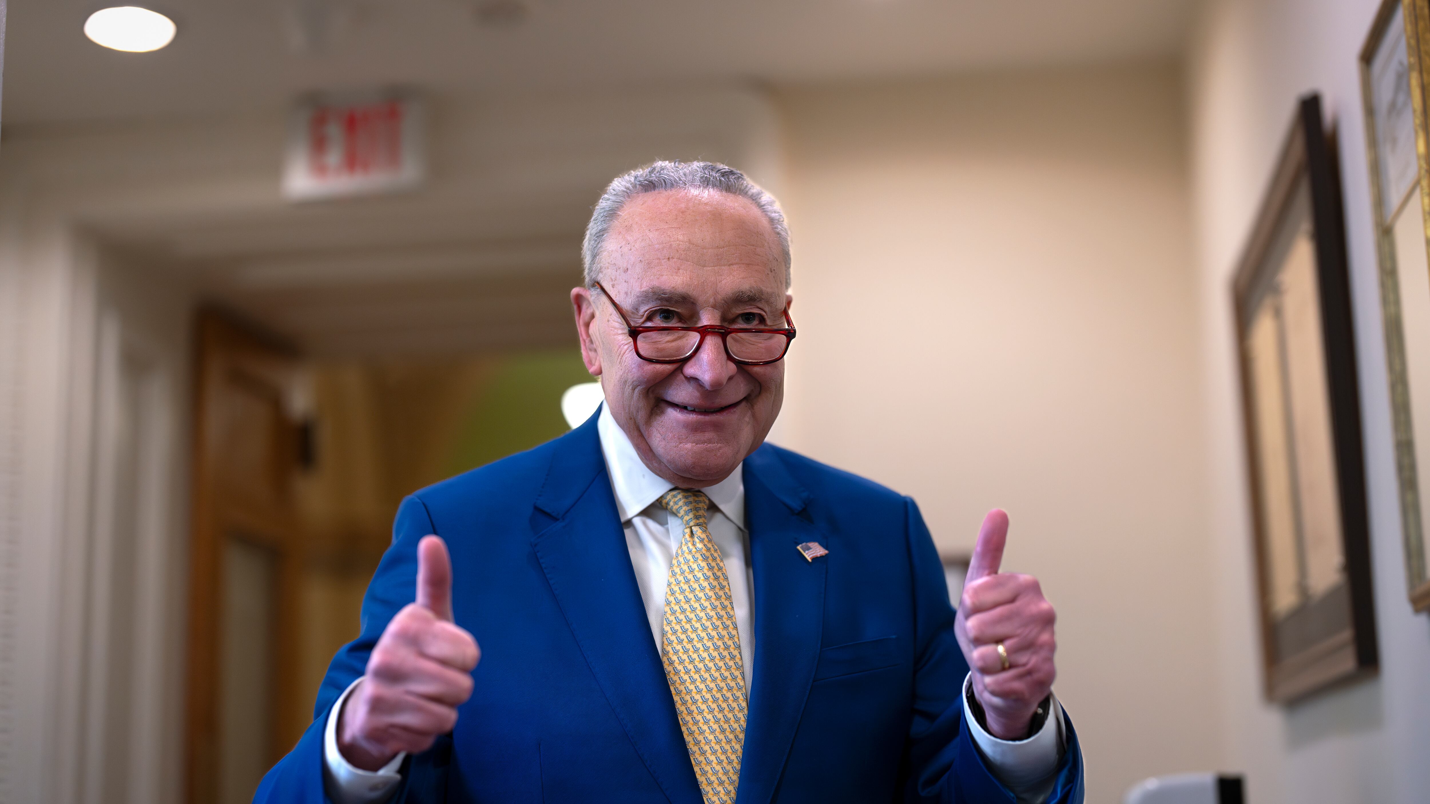 Senate majority leader Chuck Schumer signals success to reporters after a divided Senate passed an emergency spending package to provide send military aid to Ukraine and Israel (J. Scott Applewhite/AP)