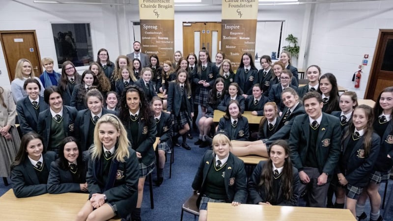 Pupils from St Joseph&#39;s Donaghmore in Tyrone who will appear as extras in the next series of Derry Girls, along with cast members 
