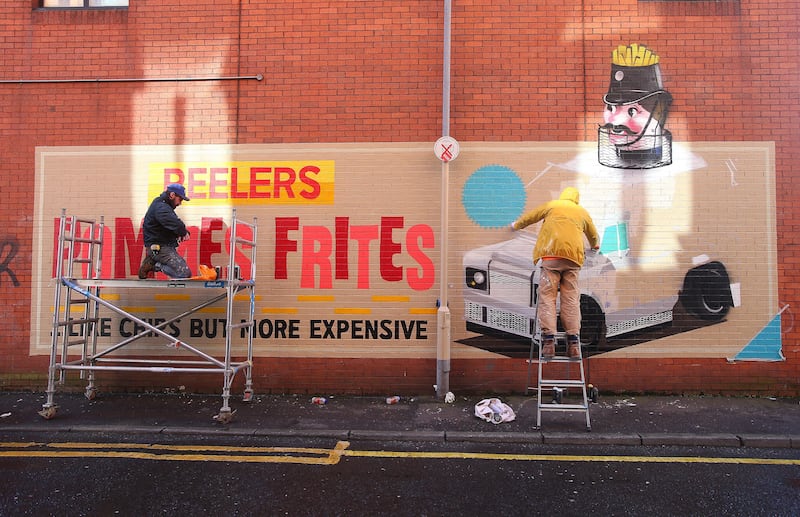 Glasgow artists Conzo Throb and Ciaran Glöbel create a locally-themed mural  “Pommes frites … like chips but more expensive.”