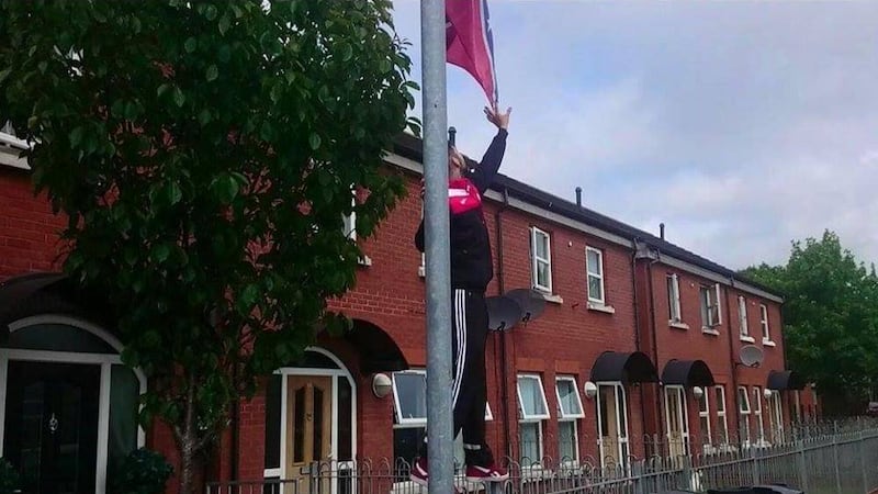 Members of East Belfast FC remove racist flag from outside the home of young player 