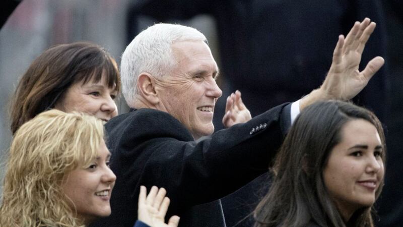 Vice President Mike Pence, accompanied by his family, waves as they walk during the inauguration parade in Washington on Friday. Picture by Matt Rourke, Associated Press 