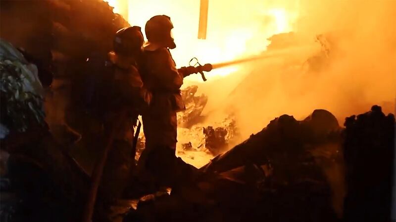In an image made from video, firefighters work on a fire in Nairobi, Kenya (AP)