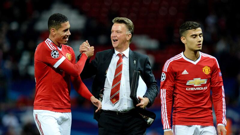 Louis Van Gaal and Chris Smalling celebrate Wednesday's win against Wolfsburg in the Champions League