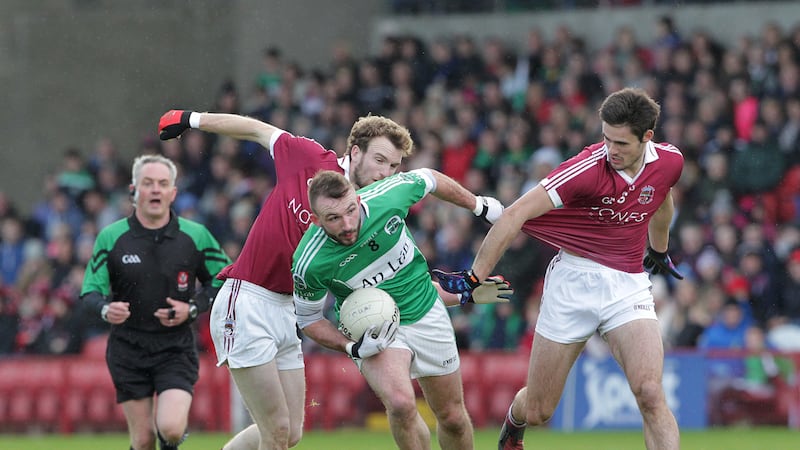 Slaughtneil's P&aacute;draig Cassidy and Chrissy McKaigue get to grips with the Loup's Terence O'Brien during last Sunday's Derry Senior Football Championship final at Celtic Park. All three players make it onto S&eacute;amus Mullan's Derry Allstars panel for 2016 &nbsp;<br />Picture by Margaret McLaughlin&nbsp;