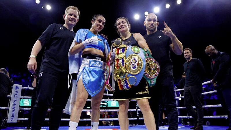 Katie Taylor celebrates with her belts alongside opponent Karen Carabajal after winning their Undisputed Lightweight World Title fight at the OVO Arena Wembley Picture: Steve Paston/PA 