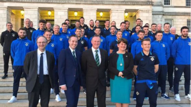 Front from left, education minister Peter Weir, minister for communities Paul Givan and first minister Arlene Foster join Northern Ireland football manager Michael O'Neill and the Northern Ireland soccer squad for a reception at Stormont