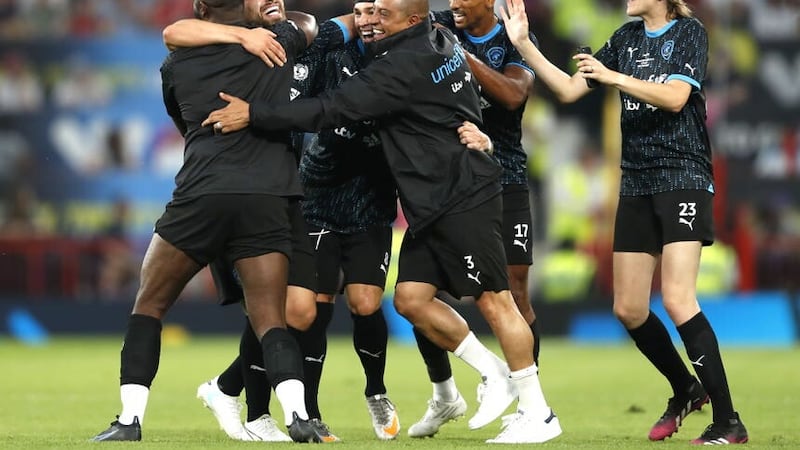 Soccer Aid World XI’s Kem Cetinay, second left, celebrates scoring in the 4-2 defeat of England at Old Trafford (Will Matthews/PA)
