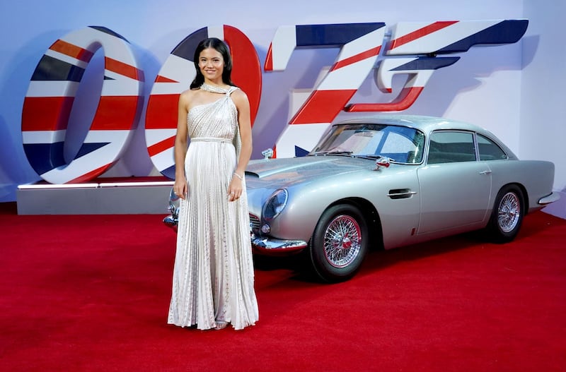 Emma Raducanu stands in front of an Aston Martin at the world premiere of No Time To Die