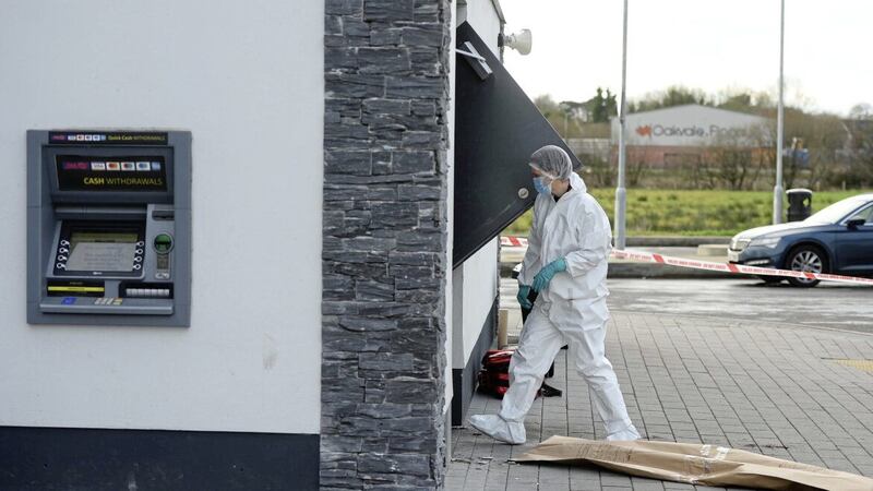 A forensic officer at the scene of an attempted ATM robbery in Toome. Picture by Mark Marlow 