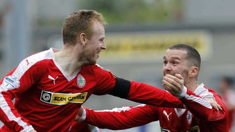 George McMullan celebrates with Marty Donnelly after scoring a wonder goal against Linfield 