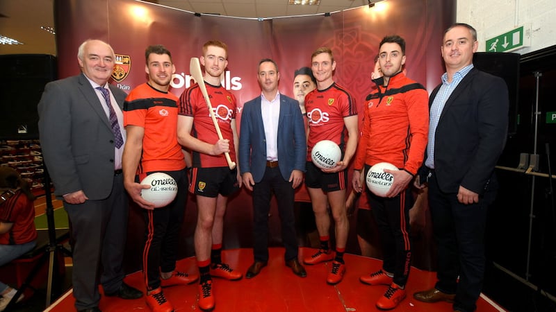 Down county secretary Sean Og McAteer and county players David McKibbin, Rian Brannigan, Caolan Mooney, and Ryan Johnston at the official launch of the new Down GAA jersey with Daniel and Adrian Strain of EOS IT Solutions