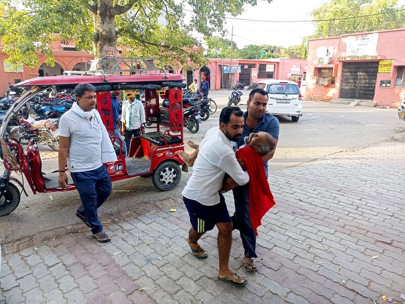 An elderly man is carried to a hospital in Ballia district, in northern Uttar Pradesh state 