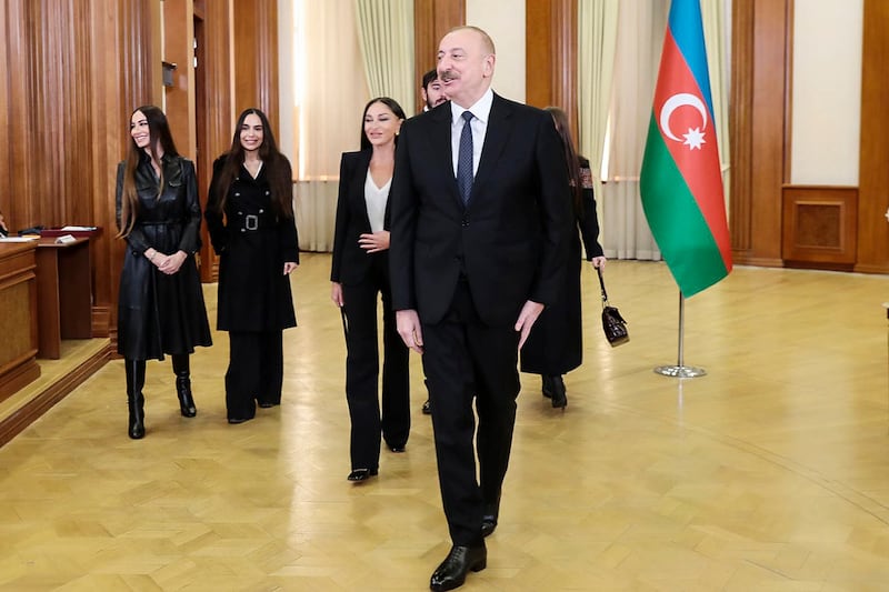 Azerbaijan’s President Ilham Aliyev, centre, his wife and vice president Mehriban Alieva, left behind him, and other family members after voting in Khankendi, Karabakh region, Azerbaijan (Azerbaijani Presidential Press Office via AP)