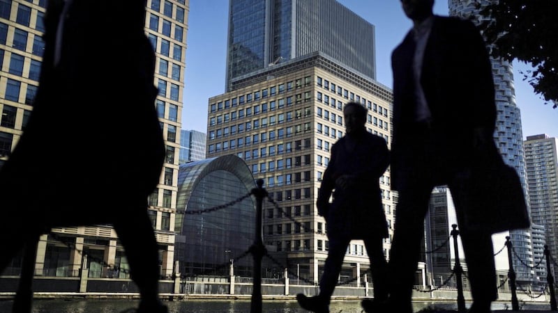 Office workers and commuters walking through Canary Wharf in London during the morning rush hour as it is revealed that the bosses of the UK&#39;s biggest companies saw their pay surge by 16 per cent last year 