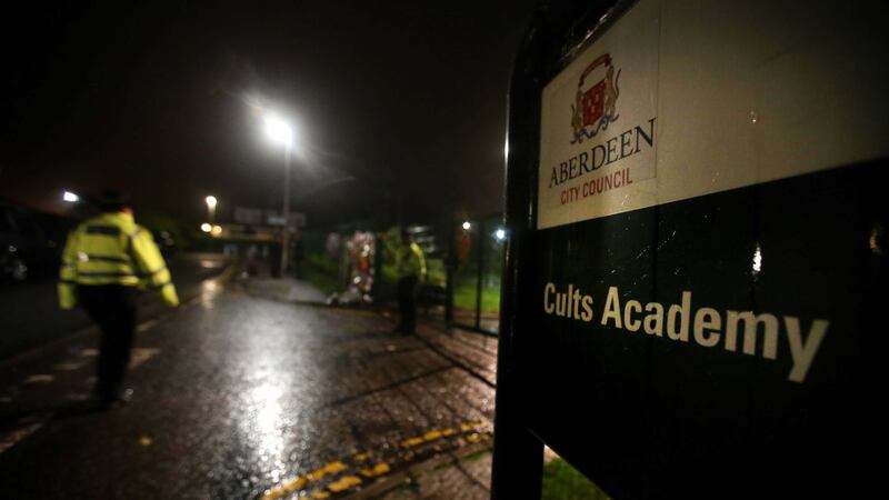 A police officer at the gates of Cults Academy in Aberdeen, where a 16-year-old boy died after being stabbed at the secondary school. Picture by Andrew Milligan/PA Wire&nbsp;