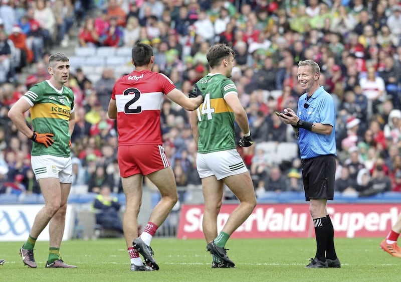 Referee Joe McQuillan chats with David Clifford of Kerry (centre) while Derry&#39;s Chrissy McKaigue looks on. Picture Margaret McLaughlin 