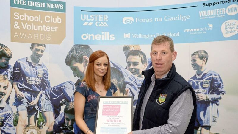 Liam Howlett, coaching and games development officer with Cumann Pheadair Naofa, accepts the &lsquo;Coaching Initiative of the Year&rsquo; award from Martina Madden of O&#39;Neills Sportswear 