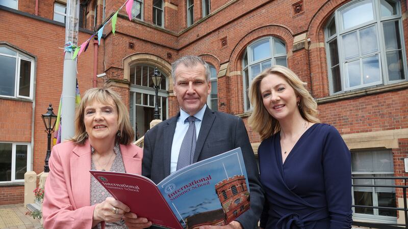 Wife Alice and daughter Mary Alice, of the late Éamon Phoenix, at St Mary's College in Belfast, with The Irish News editor Noel Doran. Picture by Hugh Russell