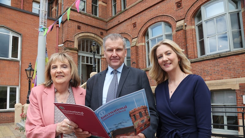 Wife Alice and daughter Mary Alice, of the late Éamon Phoenix, at St Mary's College in Belfast, with The Irish News editor Noel Doran. Picture by Hugh Russell