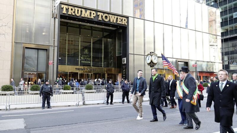 Irish Taoiseach Leo Varadkar (green scarf) and his partner Matt Barrett pass Trump Tower as they walk down 5th Avenue in the St Patrick&#39;s Day parade in New York City. PRESS ASSOCIATION Photo. Picture date: Saturday March 17, 2018. See PA story IRISH Taoiseach. Photo credit should read: Niall Carson/PA Wire. 