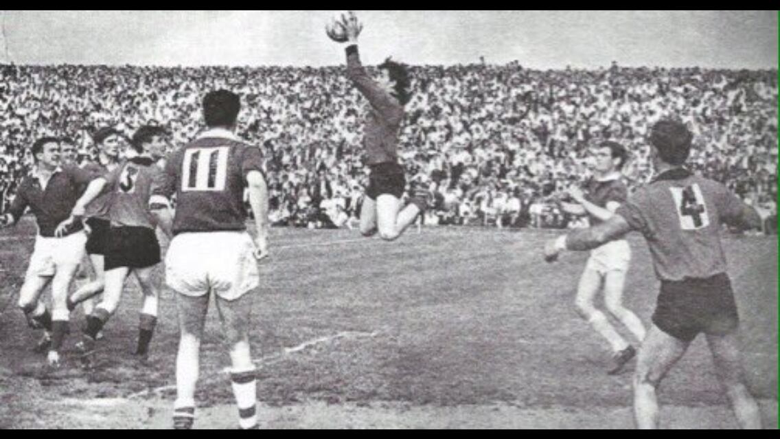 Brendan Sloan rises high to claim the ball for Down during the 1968 Ulster Senior Football Championship final against Cavan at a packed Casement Park in west Belfast. Eugene Treanor was also a member of the Down ’68 squad. Picture courtesy of Down County Board PRO Fiona Murphy<br /> 