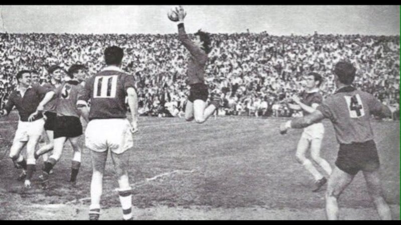 Brendan Sloan rises high to claim the ball for Down during the 1968 Ulster Senior Football Championship final against Cavan at a packed Casement Park in west Belfast. Eugene Treanor was also a member of the Down &rsquo;68 squad. Picture courtesy of Down County Board PRO Fiona Murphy<br />&nbsp;