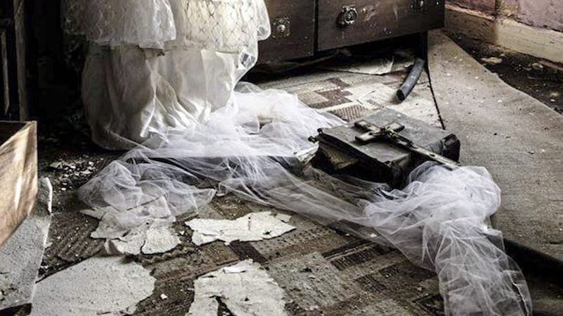 A forlorn wedding dress left in the room where its owner once lived