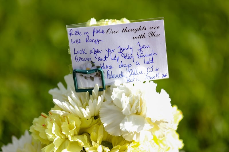 A note on flowers left in tribute on Atlantic Way in Bundoran town to Ronan Wilson from Kildress in Co Tyrone, who was killed in a hit-and-run. The nine-year-old killed had been visiting the Donegal town of Bundoran when he was struck by a vehicle on Saturday evening. Picture by Liam McBurney, PA.