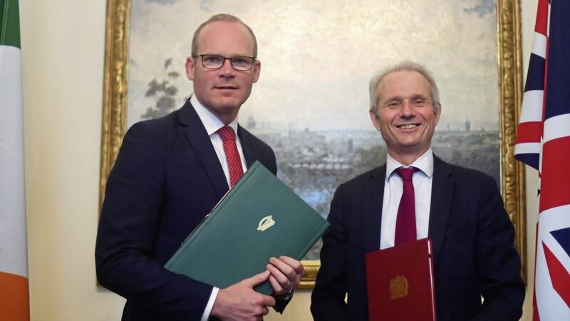 Tan&aacute;iste Simon Coveney (left) with British minister David Lidington signing a deal to preserve the Common Travel Area between the Republic and UK. Picture by Victoria Jones, Press Association 