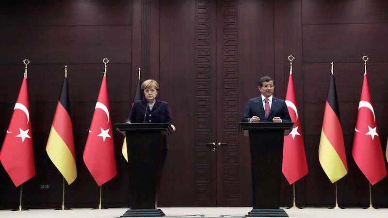 German Chancellor Angela Merkel and Turkish Prime Minister Ahmet Davutoglu speak to the media after their talks in Ankara, Turkey. Picture by Burhan Ozbilici, Associated Press
