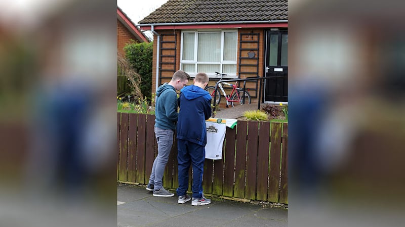 Family members place a Celtic jersey outside the house in Lurgan where Paul Gerard Curran was found dead. Picture by Mal McCann