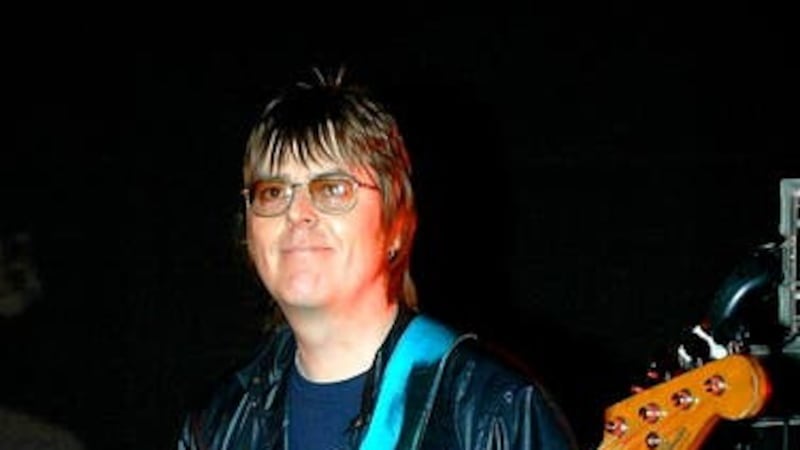 Andy Rourke on stage with Badly Drawn Boy during the Manchester Versus Cancer charity concert in 2006 (PA)