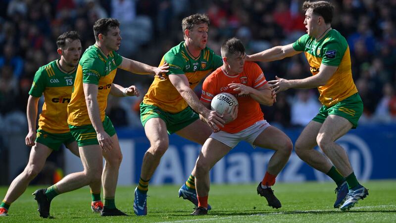 Donegal’ swamp the attack of Armagh’s Peter McGrane during todays Allianz GAA Football league Div 2 final at Croke Park, Dublin.  Picture Mark Marlow