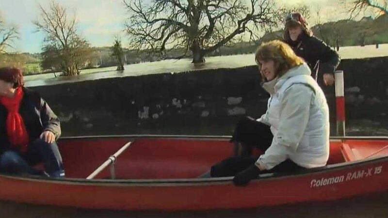 Labour leader Joan Burton goes into a canoe to see the damage caused by flooding in Thomastown, Co Kilkenny 