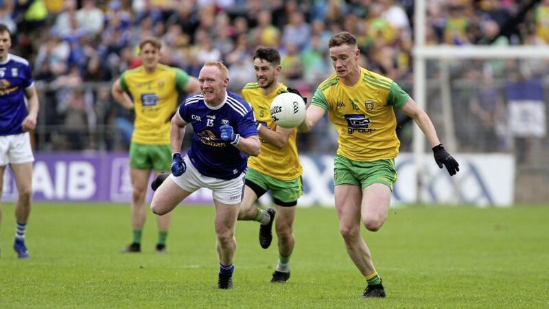 Donegals Ciaran Thompson (right), with team-mate Ryan McHugh following up, in action against Cavan&#39;s Cian Mackey in the Ulster Senior Football Championship final at Clones on Sunday June 23 2019. Picture by Seamus Loughran. 