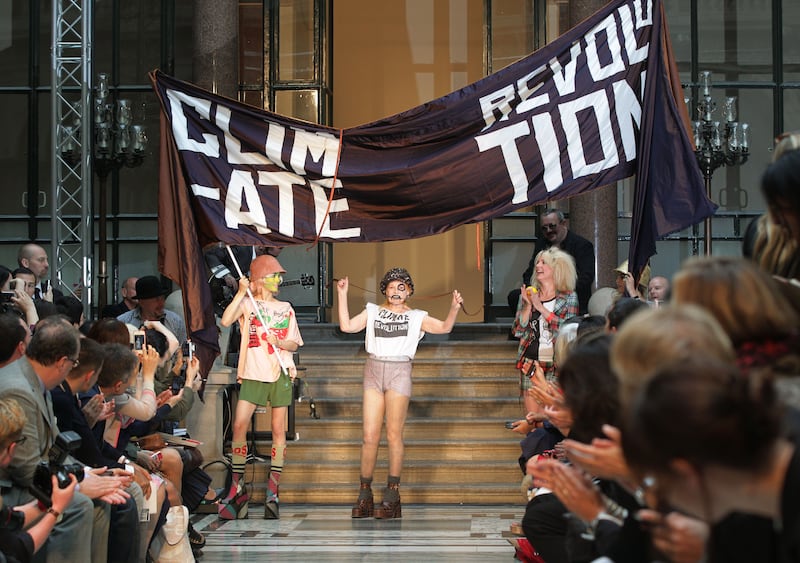 Vivienne Westwood on the runway in 2012 in a T-shirt saying 'climate revolution