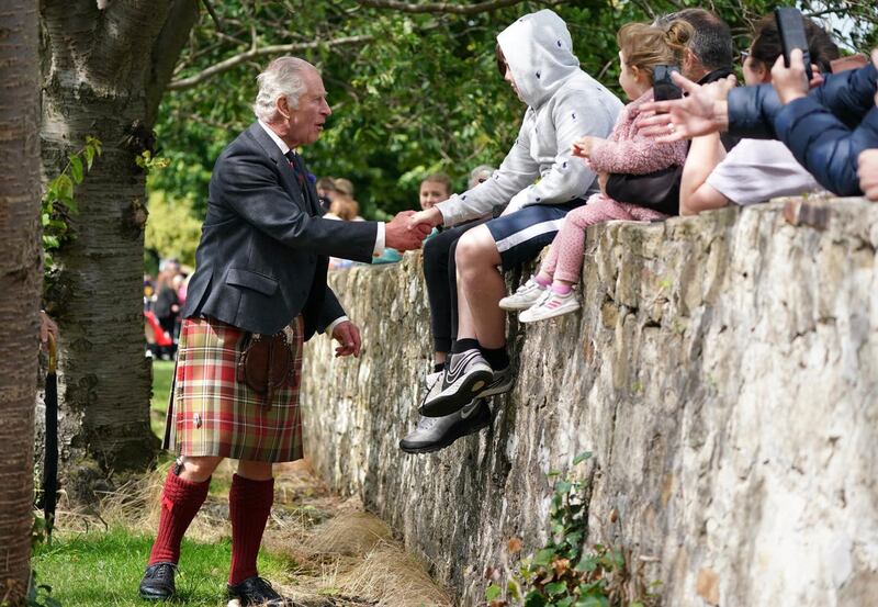 King shaking hands with children during Scotland visit
