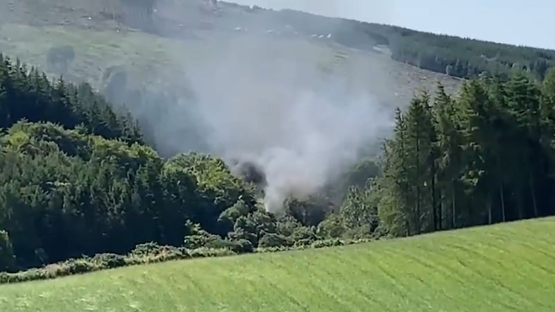 Screen grab from BBC Scotland showing smoke billowing from the train on the track in the countryside near Stonehaven, Aberdeenshire&nbsp;