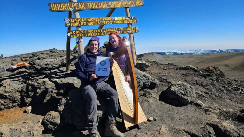 Siobhan Brady (right) with her harp on Mount Kilimanjaro as she attempts to break the world record for highest altitude harp performance (The Highest Harp Concert Team/PA