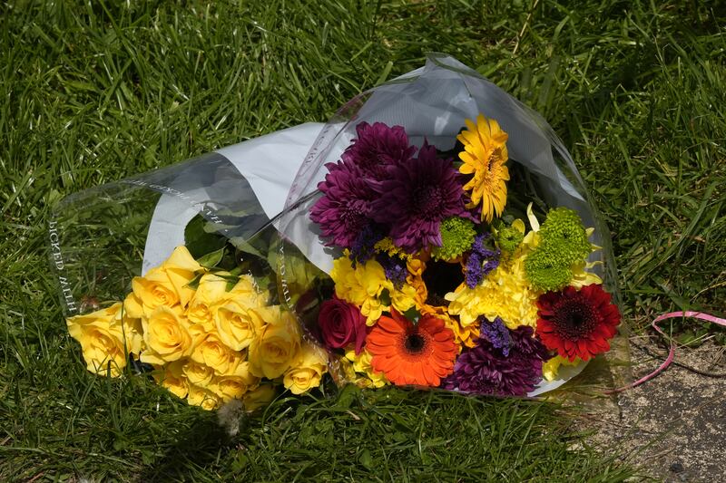 A floral tribute at the scene of the house fire in Bradford