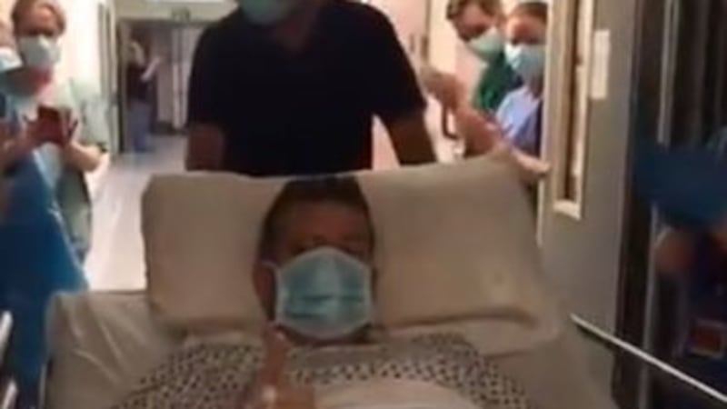 Niall Murphy, 43, gave the thumbs up in video footage of him being wheeled from ICU. Picture credit: still taken from Q Radio video. &nbsp;